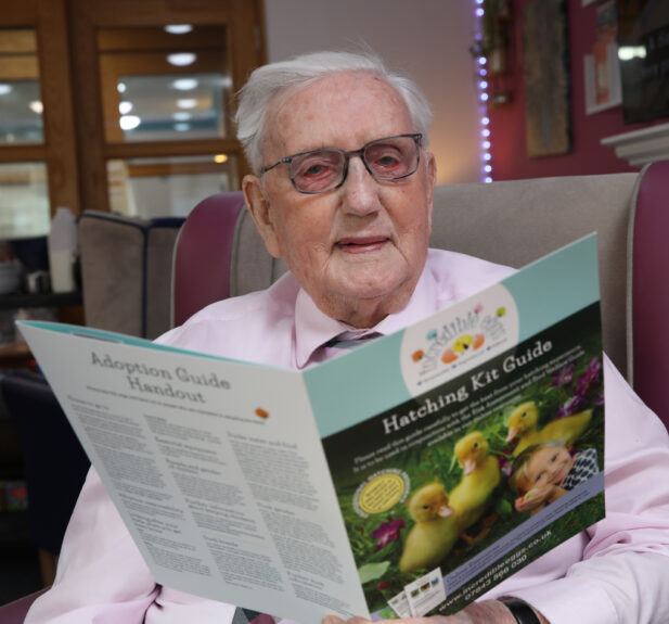 Resident at Russell Churcher Court reading.
