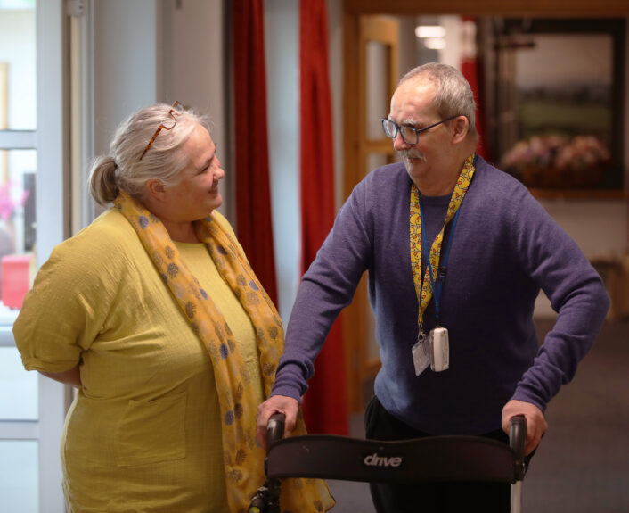 Care manager chats with resident at Russell Churcher Court care home.